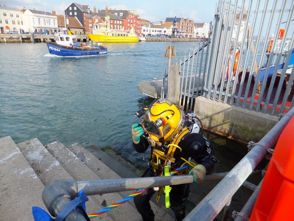 Diver ascends Ferry Road Steps having prepared the sheet piling ready for the welding to begin